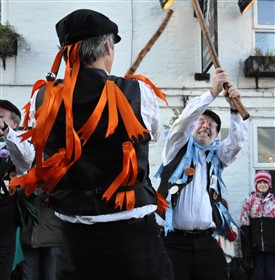 Photo:Chris Rose and Sam Millard, founder members, dancing The Turk's Head, a stick dance composed by Broadstone Morris, on Boxing Day 2010 at the Blacksmith's Arms, Everton