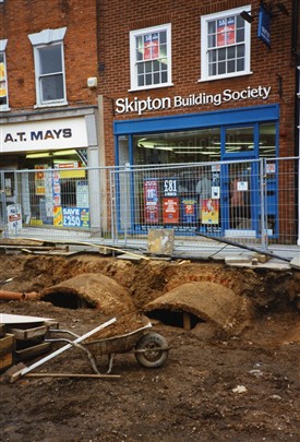 Photo:Re-paving Newark Market Place, July 1994.  Cellars project well in front of the shops.