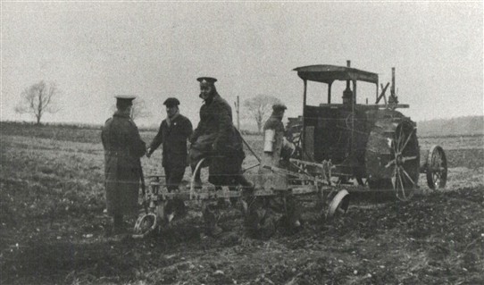 Photo:Uniformed soldiers assist with using an early tractor at Black Hills Farm, Edwinstowe