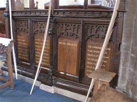 Photo:Names of the fallen inscribed at the base of the chancel screen
