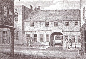 Photo:An early engraving of the Saracen's Head with the position of the milestone visible to the left of the archway