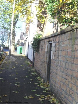 Photo:The gate and wall to the cemetery. The road at the top of the picture is Forest Road East.