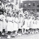 Photo:9.  After the judging was over the devices paraded around the town preceded by children with garlands of flowers.  Pictured here among the procession in 1938 or 1939 is Jean Ragsdale (third from left).